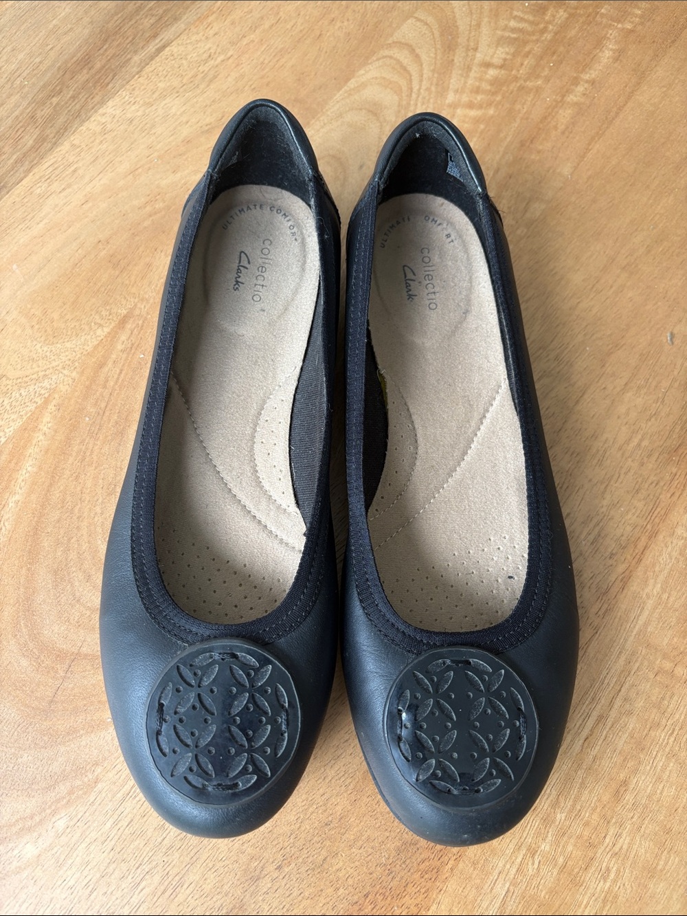 Clarks Black Leather Slip-On Ballet Flats with Decorative Medallion